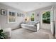 Cozy living room with a soft rug, neutral-toned sofa and backyard access at 729 Mial St, Raleigh, NC 27608