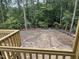 View of the wooded backyard and the prepped yard with black border and green pipe at 79 Oldham Estate Dr, Chapel Hill, NC 27517