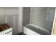 Bathroom showcasing gray tiled walls and a new bathtub at 79 Oldham Estate Dr, Chapel Hill, NC 27517