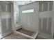 A newly constructed bathroom showcasing a tiled shower with a built-in bench at 79 Oldham Estate Dr, Chapel Hill, NC 27517