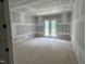 Bedroom with neutral paint, carpet flooring and double doors leading to a balcony at 79 Oldham Estate Dr, Chapel Hill, NC 27517