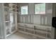 Walk in closet space featuring custom shelving and natural light from two windows at 79 Oldham Estate Dr, Chapel Hill, NC 27517