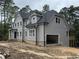 New exterior elevation of a home with gray siding, gray shingle roof, and an attached garage at 79 Oldham Estate Dr, Chapel Hill, NC 27517