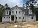 New two-story home with gray siding, black roof, and inviting covered front porch at 79 Oldham Estate Dr, Chapel Hill, NC 27517