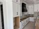 Modern kitchen with white cabinetry and a black range hood at 79 Oldham Estate Dr, Chapel Hill, NC 27517