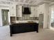 Unfinished kitchen featuring an island and white cabinets with a black range hood at 79 Oldham Estate Dr, Chapel Hill, NC 27517