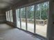 Spacious room featuring sliding doors leading to a new wooden deck overlooking a wooded area at 79 Oldham Estate Dr, Chapel Hill, NC 27517