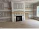 Cozy living room with a fireplace and built-in shelving at 79 Oldham Estate Dr, Chapel Hill, NC 27517