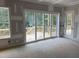 Spacious room featuring sliding doors leading to a new wooden deck overlooking a wooded area at 79 Oldham Estate Dr, Chapel Hill, NC 27517