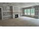 Spacious living room featuring fireplace with wood mantle and built in shelving at 79 Oldham Estate Dr, Chapel Hill, NC 27517