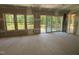 Spacious room featuring sliding doors leading to a new wooden deck overlooking a wooded area at 79 Oldham Estate Dr, Chapel Hill, NC 27517