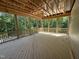 Large screened porch with natural wood floors and screens showcasing the surrounding trees at 79 Oldham Estate Dr, Chapel Hill, NC 27517