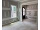 A room with neutral paint, hardwood flooring, natural light from one window, and entry door at 79 Oldham Estate Dr, Chapel Hill, NC 27517