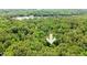 An aerial view of densely wooded acreage with a down-pointing arrow indicating the property at 800 Shady Lawn Rd, Chapel Hill, NC 27514