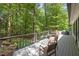Enjoy nature on this expansive deck with wooded views and comfortable seating, perfect for relaxing or entertaining guests at 800 Shady Lawn Rd, Chapel Hill, NC 27514