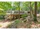 View of back exterior with deck, complemented by surrounding nature for peaceful outdoor enjoyment and privacy at 800 Shady Lawn Rd, Chapel Hill, NC 27514