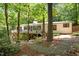 The rear exterior is surrounded by trees and a large back deck, perfect for enjoying privacy and nature views at 800 Shady Lawn Rd, Chapel Hill, NC 27514