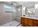 Contemporary bathroom with a glass-enclosed shower, marble accents, and wood vanity with brass hardware at 800 Shady Lawn Rd, Chapel Hill, NC 27514
