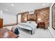 Bright bedroom with exposed brick wall and a cozy seating area, creating an inviting retreat at 800 Shady Lawn Rd, Chapel Hill, NC 27514