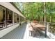 Spacious outdoor deck with a dining set, perfect for entertaining and enjoying the lush surroundings at 800 Shady Lawn Rd, Chapel Hill, NC 27514
