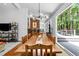 Spacious dining room with large wooden table, modern lighting, and sliding doors to the deck at 800 Shady Lawn Rd, Chapel Hill, NC 27514