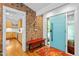 Beautiful entryway with brick accent wall, bright blue door, and a view to the kitchen at 800 Shady Lawn Rd, Chapel Hill, NC 27514