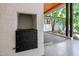 Covered outdoor area featuring brick fireplace with iron door and view of home's exterior at 800 Shady Lawn Rd, Chapel Hill, NC 27514