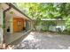 Charming home exterior with inviting front porch surrounded by trees and lush landscaping at 800 Shady Lawn Rd, Chapel Hill, NC 27514