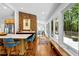 Hallway featuring wood floors, brick accent wall, and expansive windows at 800 Shady Lawn Rd, Chapel Hill, NC 27514