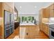 Bright, spacious kitchen features a large island with white countertop and stainless steel appliances at 800 Shady Lawn Rd, Chapel Hill, NC 27514