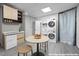 Bright kitchenette features a mini-fridge, modern cabinets, countertop sink and stacked washer/dryer at 800 Shady Lawn Rd, Chapel Hill, NC 27514