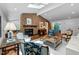 Bright living room featuring a brick fireplace, skylights, and hardwood flooring at 800 Shady Lawn Rd, Chapel Hill, NC 27514