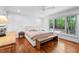 Bright main bedroom with hardwood floors, large window, and stylish furniture at 800 Shady Lawn Rd, Chapel Hill, NC 27514