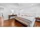 Spacious main bedroom with a large bed, hardwood floors, and neutral decor at 800 Shady Lawn Rd, Chapel Hill, NC 27514