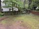 Fenced backyard with mature trees and green grass at 803 W Club Blvd, Durham, NC 27701