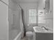 Bathroom with a white vanity, toilet, shower with curtain, and a window with natural light at 803 W Club Blvd, Durham, NC 27701