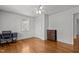 Bedroom with hardwood floors, a large window, neutral walls, a ceiling fan, and a dark dresser at 803 W Club Blvd, Durham, NC 27701