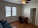 Bedroom featuring hardwood floors, a ceiling fan and two windows bringing in natural light at 803 W Club Blvd, Durham, NC 27701