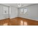 Large bedroom featuring hardwood floors, natural light, and a modern ceiling fan at 803 W Club Blvd, Durham, NC 27701