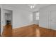 Spacious bedroom with hardwood floors and neutral paint color with access to another room at 803 W Club Blvd, Durham, NC 27701