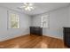 Bedroom with two large windows and hardwood floors is illuminated by a modern ceiling fan at 803 W Club Blvd, Durham, NC 27701