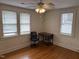 This bedroom features hardwood floors and three windows for natural light at 803 W Club Blvd, Durham, NC 27701