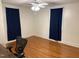 This bedroom has hardwood floors, new curtains, and fresh paint at 803 W Club Blvd, Durham, NC 27701