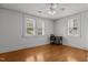 Bright bedroom featuring hardwood floors, natural light, and three large windows with backyard views at 803 W Club Blvd, Durham, NC 27701