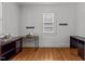 Comfortable bedroom featuring hardwood floors, neutral walls, and natural light from a window at 803 W Club Blvd, Durham, NC 27701