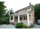 Charming two-story home featuring a welcoming front porch with classic white columns at 803 W Club Blvd, Durham, NC 27701