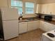 Bright kitchen with white cabinets, modern appliances, and a window over the sink at 803 W Club Blvd, Durham, NC 27701