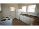 Well-lit kitchen with white appliances, ample counter space, and double windows at 803 W Club Blvd, Durham, NC 27701