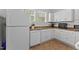 Galley-style kitchen with white appliances, ample counter space, and linoleum flooring at 803 W Club Blvd, Durham, NC 27701