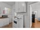 Compact kitchen featuring white appliances, linoleum floors, and efficient storage at 803 W Club Blvd, Durham, NC 27701